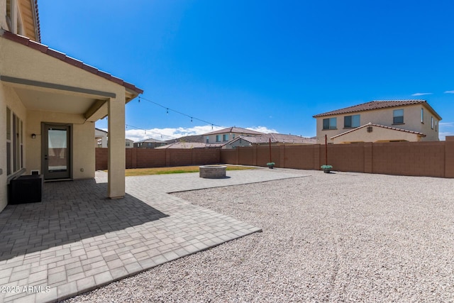 view of yard with a patio, an outdoor fire pit, and a fenced backyard