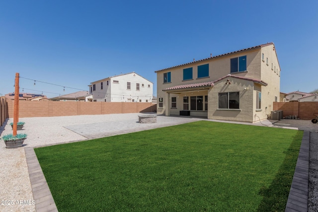 back of property with stucco siding, a patio, a lawn, and a fenced backyard