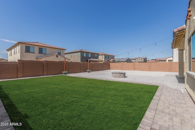 view of yard featuring a patio, a fenced backyard, and a residential view