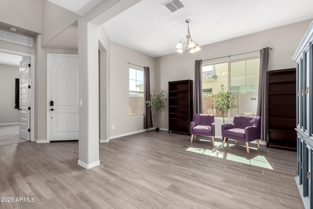 sitting room featuring visible vents, baseboards, and light wood-style floors