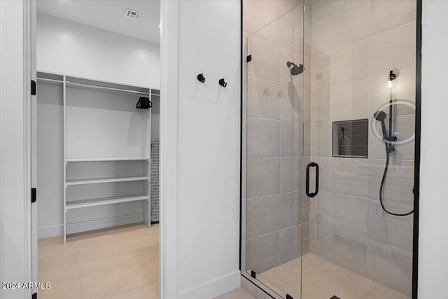 bathroom featuring walk in shower and tile patterned floors