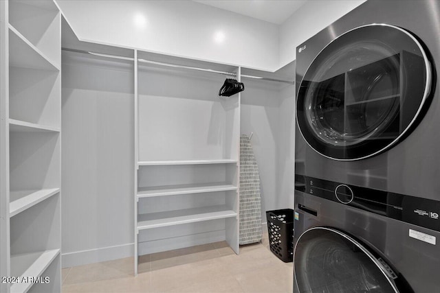 clothes washing area featuring stacked washing maching and dryer