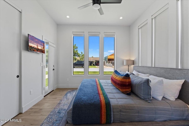 bedroom with ceiling fan, light wood-type flooring, and access to exterior