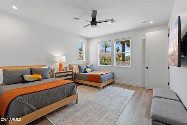 bedroom with ceiling fan and light hardwood / wood-style floors