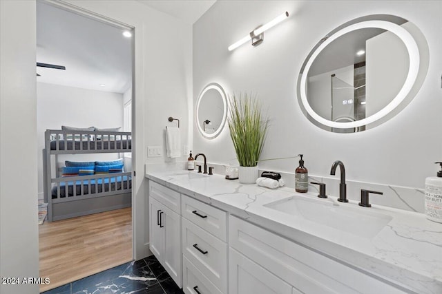 bathroom with double sink vanity and hardwood / wood-style floors