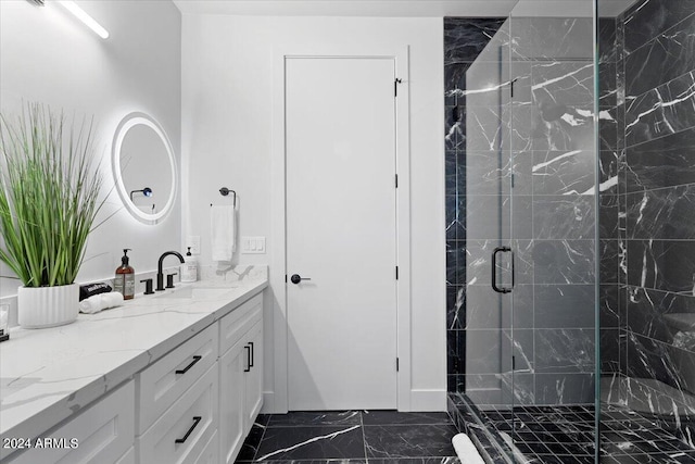 bathroom with a shower with shower door, vanity, and tile patterned flooring