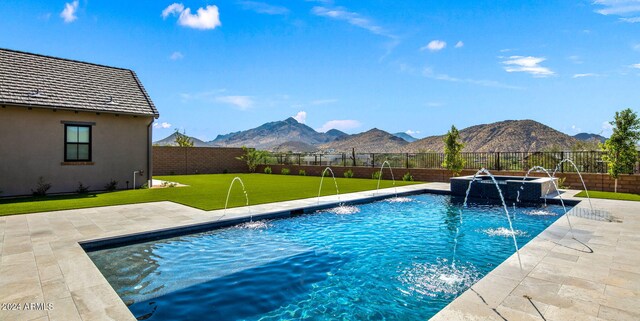 view of patio / terrace featuring ceiling fan, a mountain view, and an outdoor living space with a fire pit