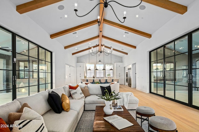 living room featuring beamed ceiling, an inviting chandelier, hardwood / wood-style floors, and high vaulted ceiling