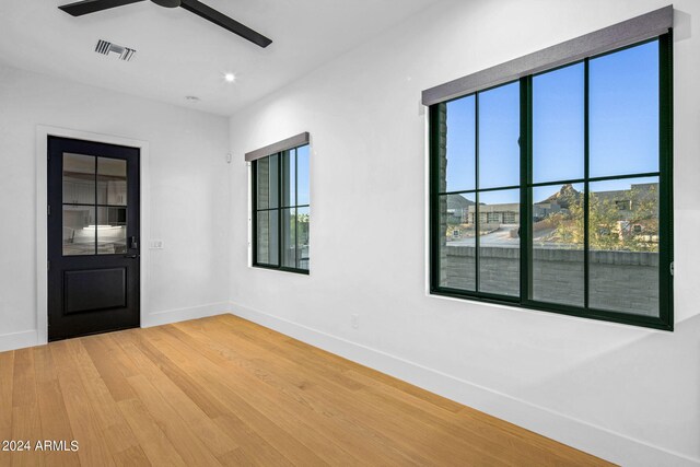 unfurnished room with ceiling fan and wood-type flooring