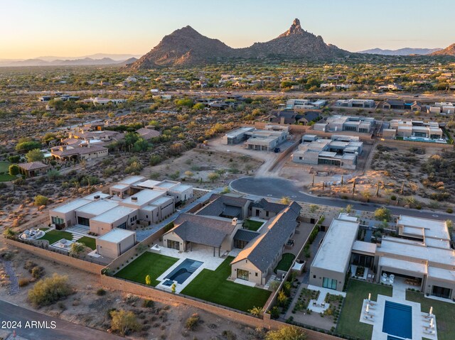 aerial view at dusk featuring a mountain view