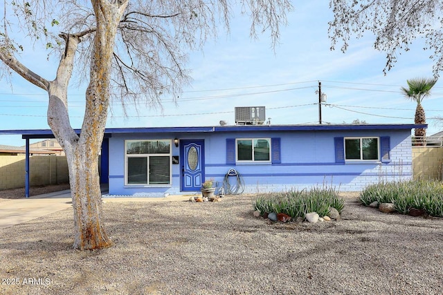 ranch-style home featuring central AC unit