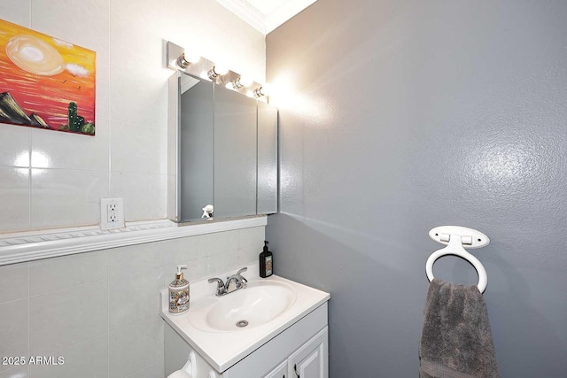 bathroom featuring crown molding and vanity