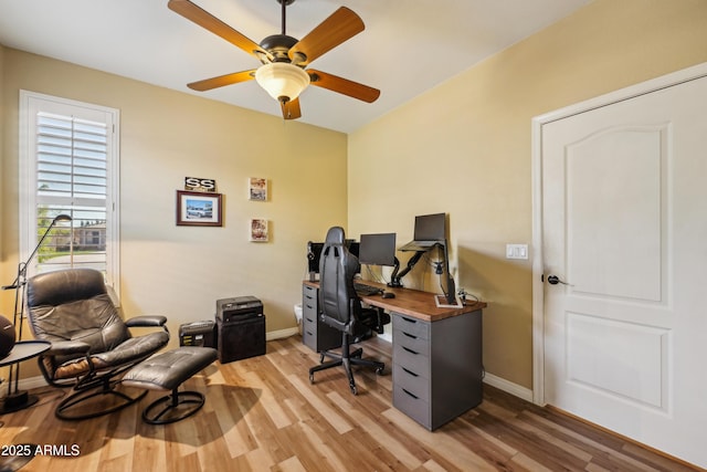 office space featuring light wood-type flooring, a ceiling fan, and baseboards