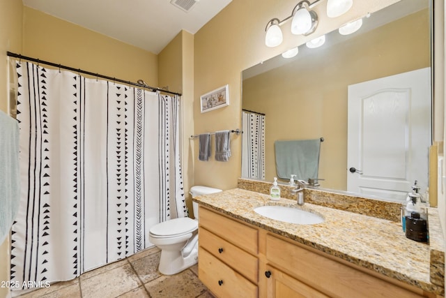 full bath with stone tile floors, visible vents, a shower with shower curtain, toilet, and vanity