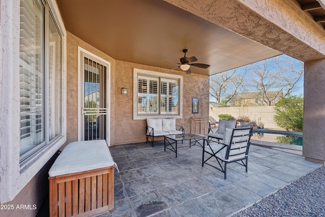 view of patio featuring fence and a ceiling fan