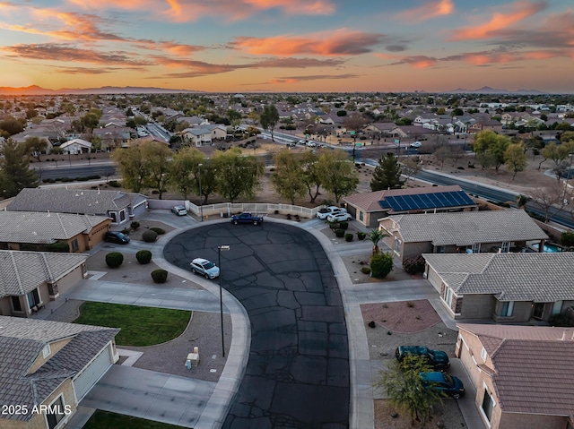 aerial view at dusk featuring a residential view