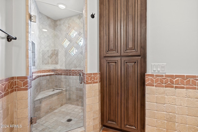 bathroom featuring tile walls and an enclosed shower