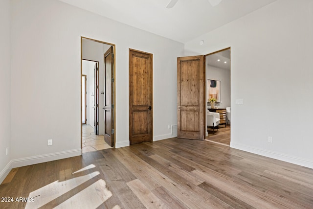 unfurnished bedroom featuring light hardwood / wood-style flooring and ceiling fan