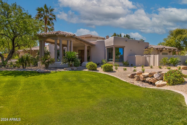 mediterranean / spanish-style house featuring a front yard