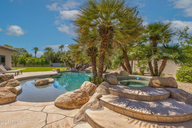 view of pool with a patio area and an in ground hot tub