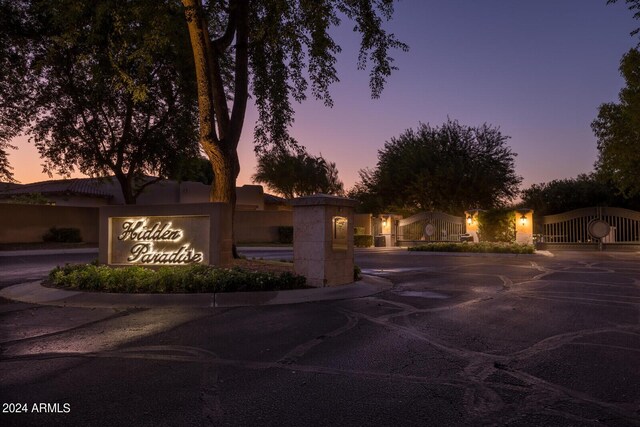 back house at dusk with a yard, an outdoor kitchen, and a patio area