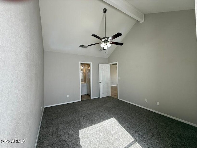 unfurnished bedroom with ceiling fan, high vaulted ceiling, ensuite bathroom, dark carpet, and beamed ceiling