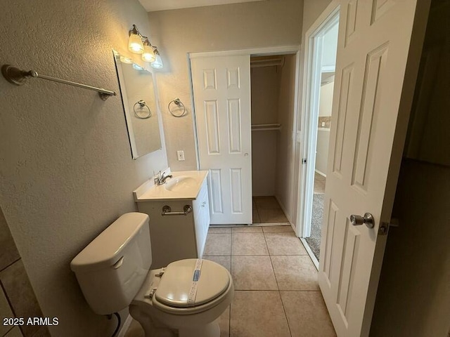 bathroom with tile patterned floors, toilet, and vanity