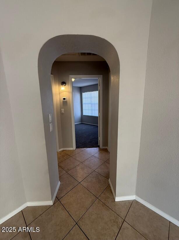 hall with light tile patterned floors