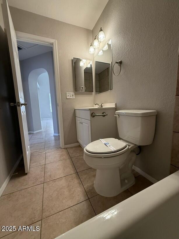 bathroom with tile patterned floors, toilet, and vanity