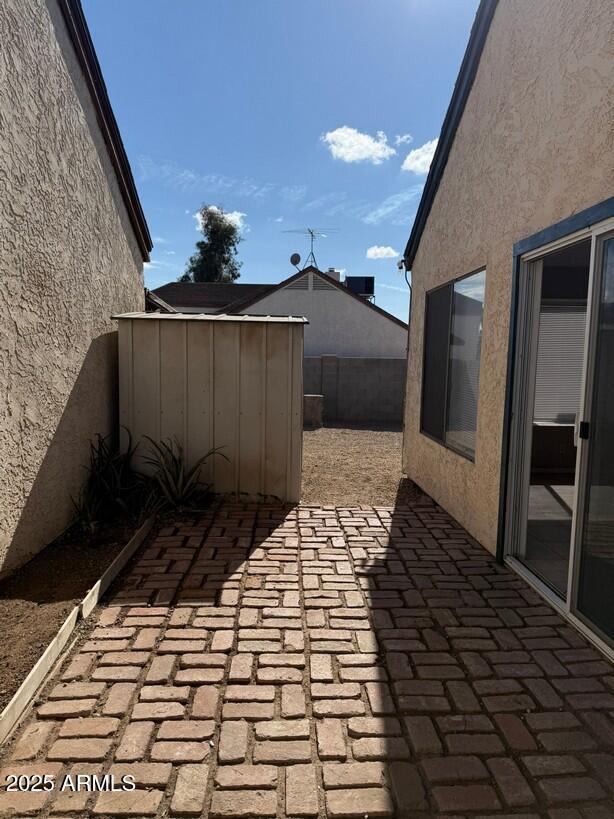 view of patio / terrace with a storage unit