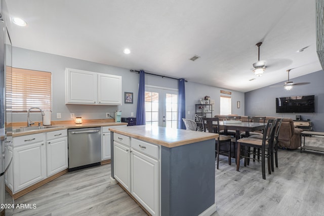 kitchen with white cabinets, a kitchen island, stainless steel dishwasher, and sink