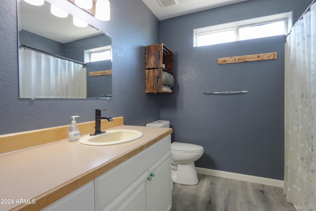 bathroom featuring hardwood / wood-style floors, vanity, and toilet