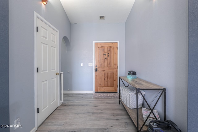 corridor with light hardwood / wood-style flooring