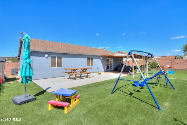 view of jungle gym featuring cooling unit, a yard, and a patio