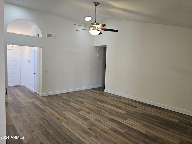 spare room with dark wood-type flooring, ceiling fan, and high vaulted ceiling