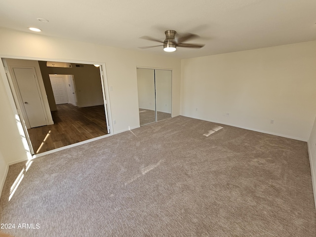 unfurnished bedroom featuring ceiling fan and dark colored carpet