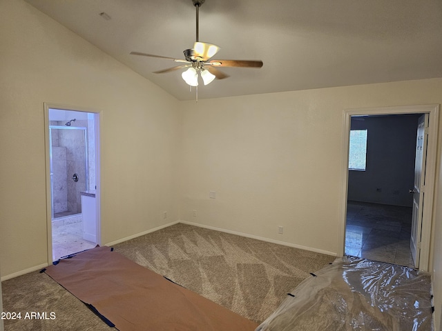 empty room featuring lofted ceiling, ceiling fan, and carpet