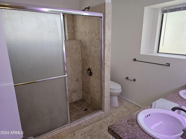 bathroom with a shower with shower door, toilet, and vanity