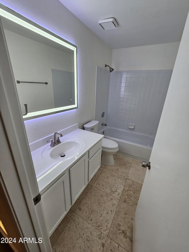 full bathroom featuring toilet, vanity, and tiled shower / bath combo