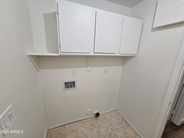 clothes washing area featuring cabinets, washer hookup, and electric dryer hookup