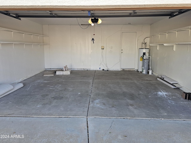 garage featuring water heater and a garage door opener