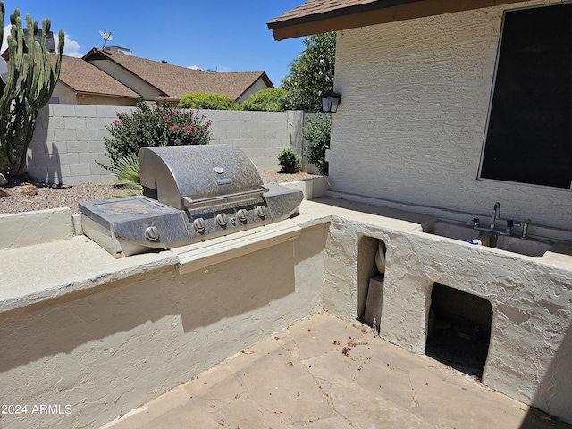 view of patio / terrace featuring grilling area, an outdoor kitchen, and sink