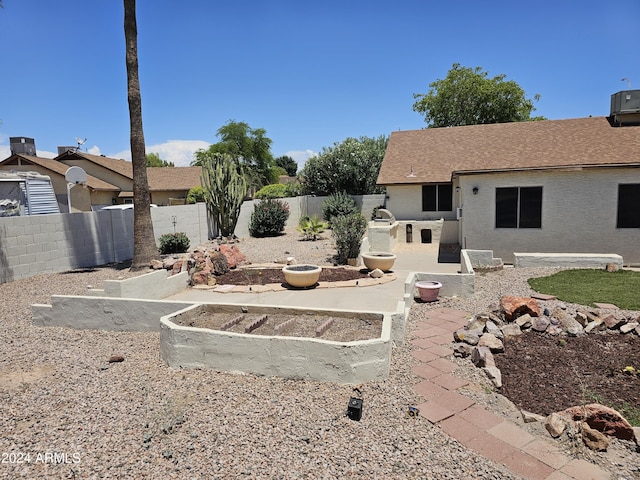 view of yard featuring central AC unit and a patio