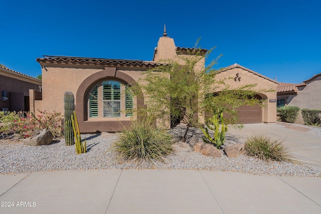 mediterranean / spanish house featuring a garage