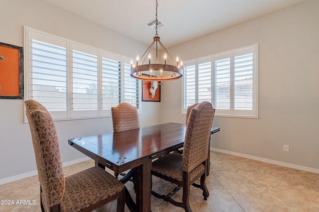 dining room featuring an inviting chandelier and light tile patterned floors