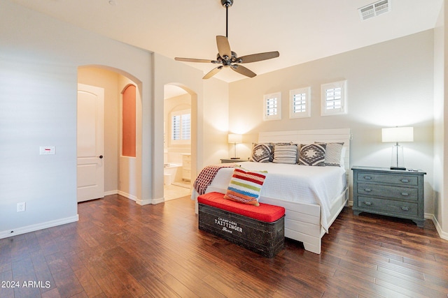 bedroom with dark hardwood / wood-style flooring, ceiling fan, and ensuite bath