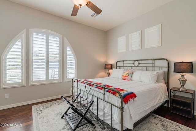 bedroom with dark hardwood / wood-style floors and ceiling fan