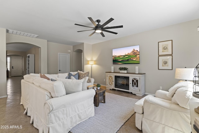 6213 W Gambit Trl, Phoenix, AZ 85083 - living room featuring arched walkways, ceiling fan, tile patterned floors, and baseboards