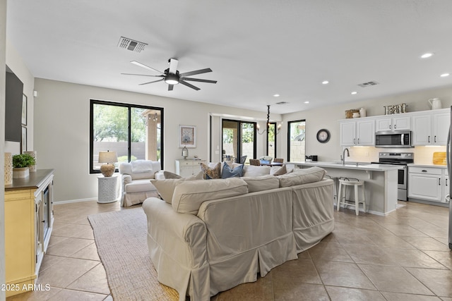 6213 W Gambit Trl, Phoenix, AZ 85083 - living room with plenty of natural light, light tile patterned floors, recessed lighting, ceiling fan, and baseboards