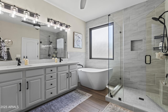 6213 W Gambit Trl, Phoenix, AZ 85083 - full bathroom with tile walls, a stall shower, double vanity, a freestanding bath, and wood finished floors